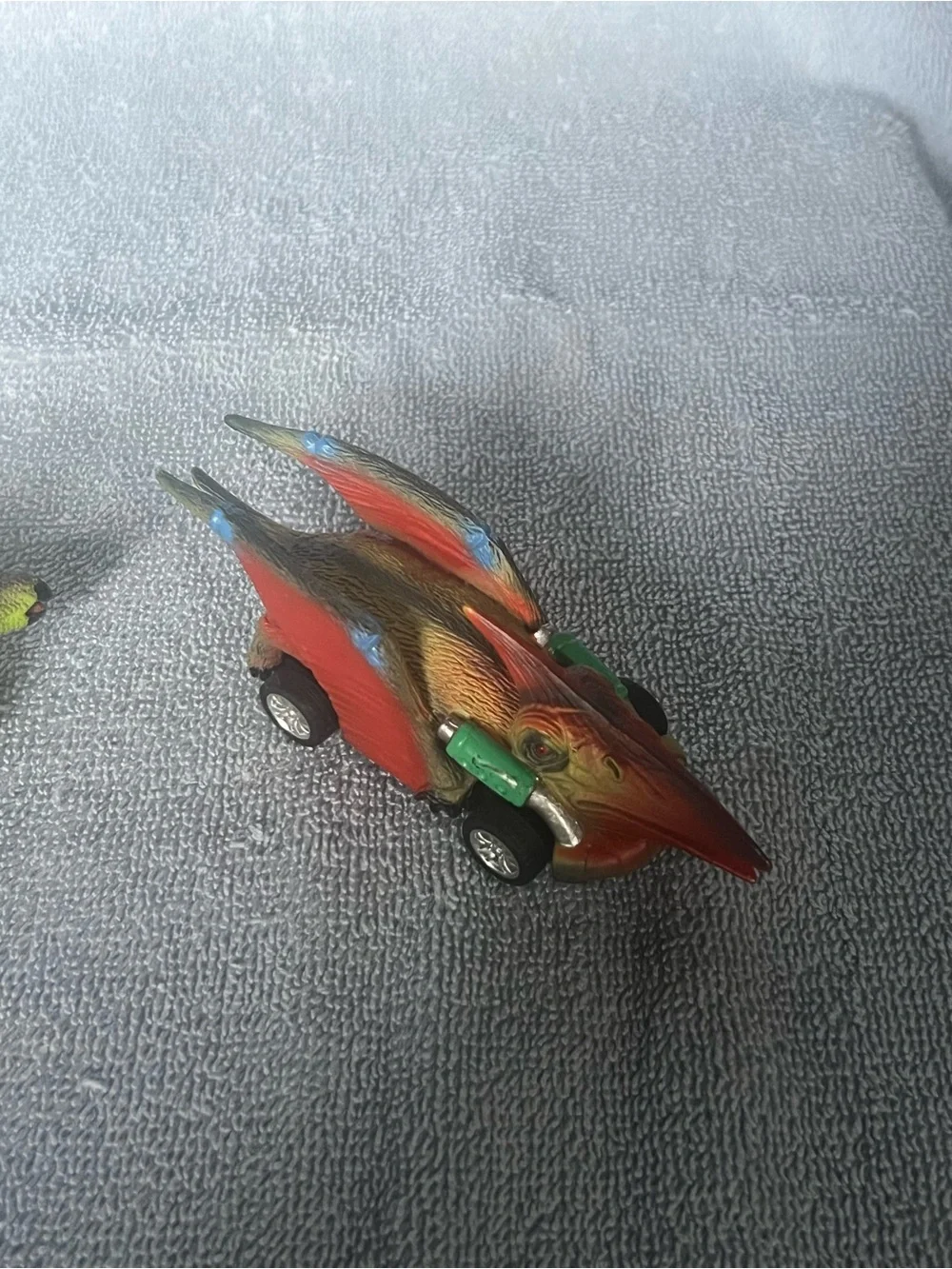 Two dinosaur pull-back toy cars